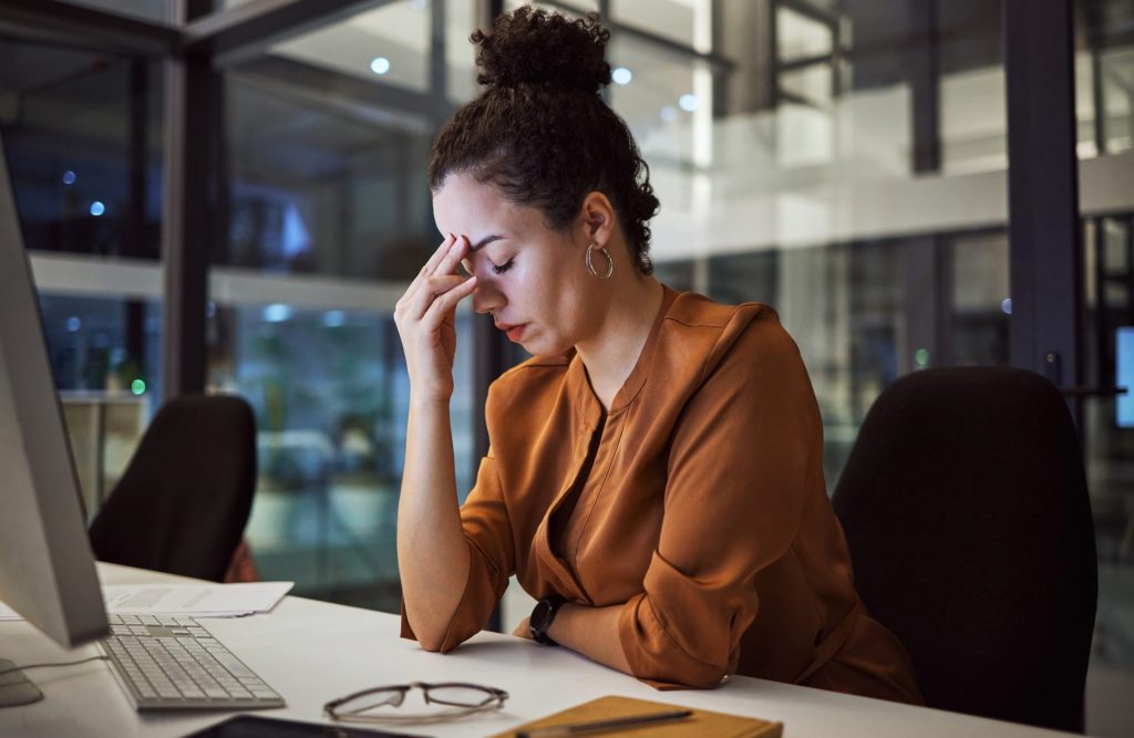 A lady at work looking stressed by her computer